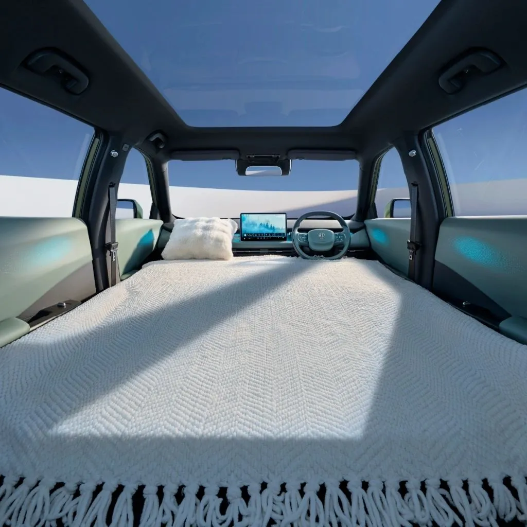 Dongfeng VIGO seats folded flat into a bed with blanket and pillow